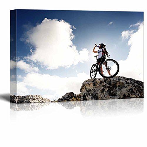 wall26 Cyclist Drinks Water on Top of a Mountain with Bike on a Sunny Day ation - Canvas Art Wall Art - 12"x18" - color: Cyclist Drinks Water, size: 18"L x 12"W